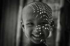 1559-G-A-smile-that-lights-up-the-shadows-—-joy-unfiltered-even-when-the-world-casts-patterns-upon-innocence