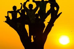 398-G-A-silhouette-that-conceals-the-worn-out-faces-of-some-slum-kids-while-highlighting-the-pure-joy-and-innocence-of-childhood
